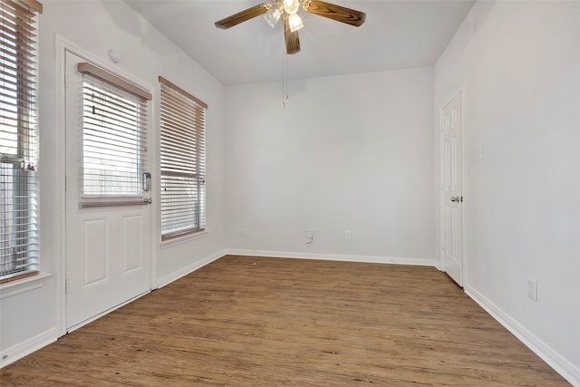 empty room with hardwood / wood-style flooring and ceiling fan