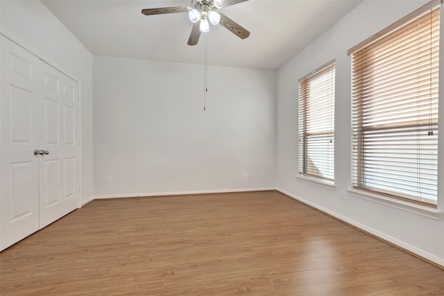 unfurnished room with light wood-type flooring and ceiling fan