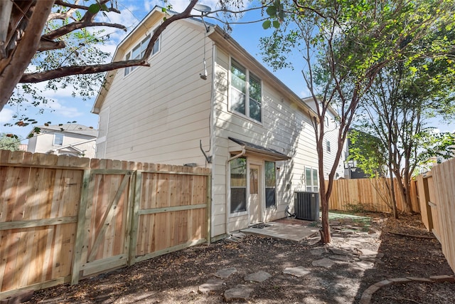 rear view of house featuring a patio area and central AC unit