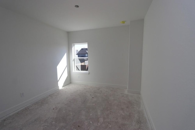 unfurnished room with concrete floors