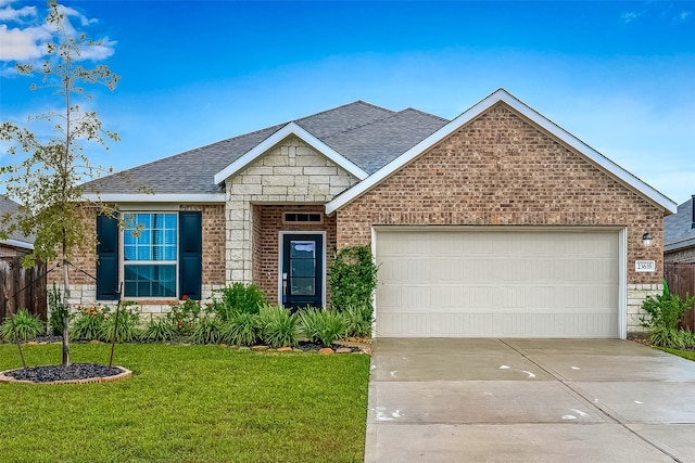 view of front of house featuring a front yard and a garage