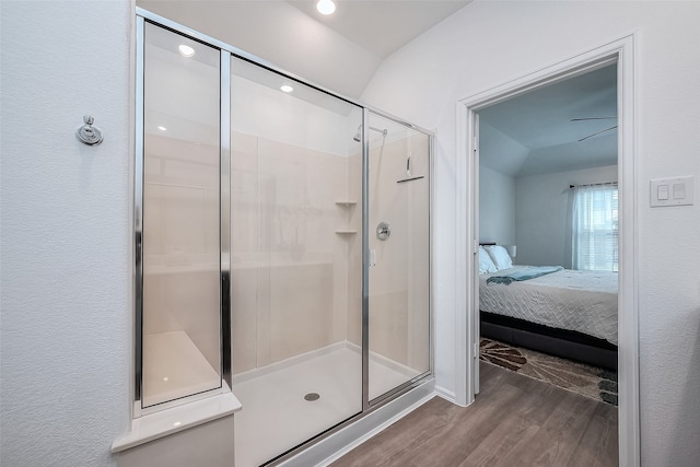 bathroom featuring a shower with shower door and wood-type flooring