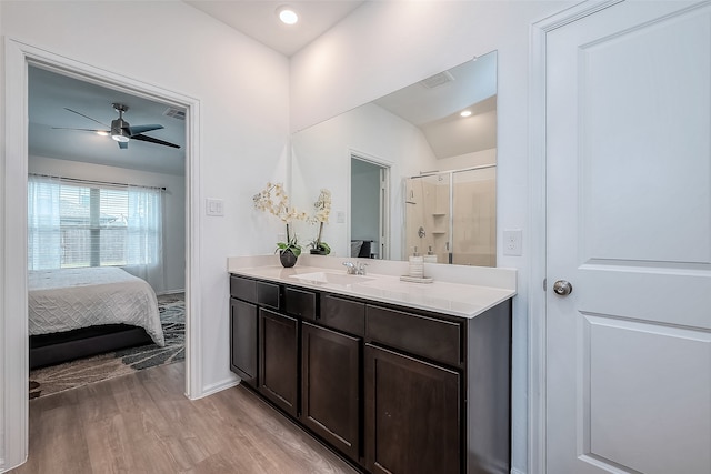 bathroom featuring vanity, ceiling fan, hardwood / wood-style flooring, and walk in shower