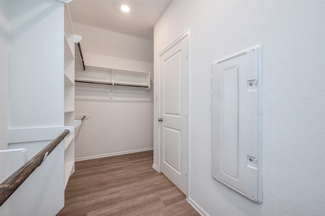 walk in closet with light hardwood / wood-style flooring