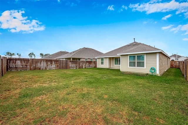 rear view of property featuring a yard