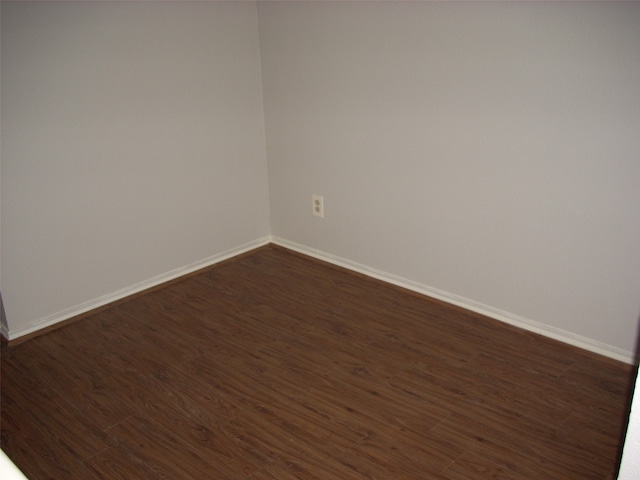 empty room with dark wood-type flooring