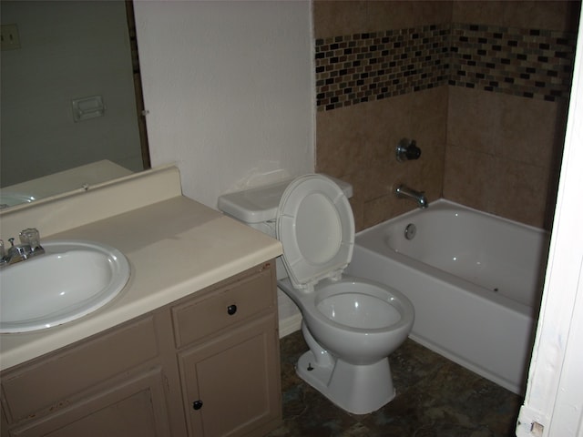 full bathroom with toilet, tiled shower / bath, and vanity