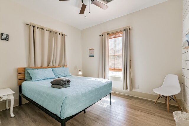 bedroom featuring wood-type flooring and ceiling fan