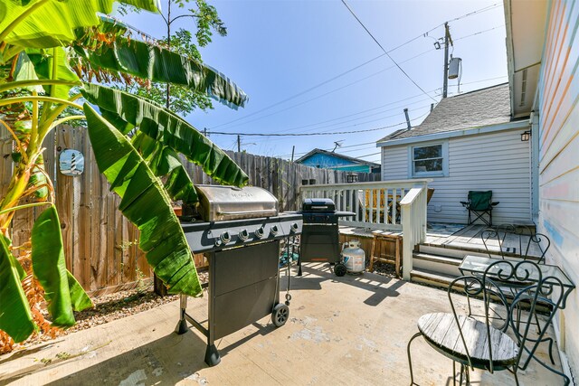 view of patio / terrace featuring a deck and a grill