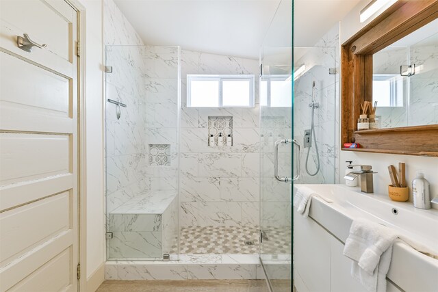 bathroom featuring vanity, an enclosed shower, and a healthy amount of sunlight