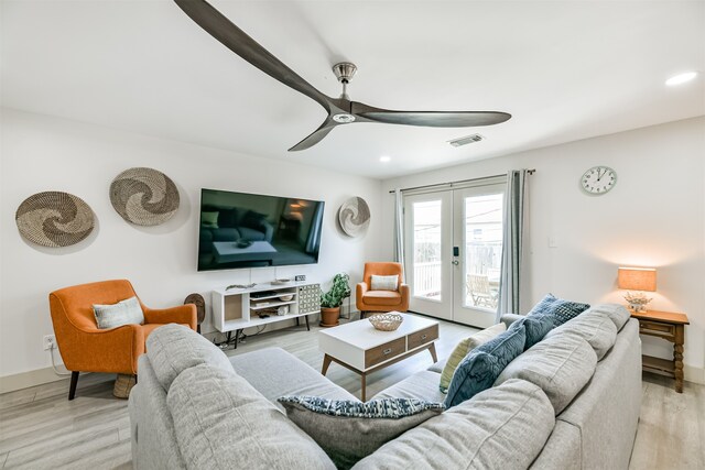 living room with french doors, light hardwood / wood-style flooring, and ceiling fan