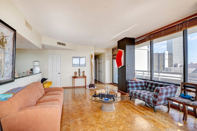 living room with a textured ceiling and light parquet floors