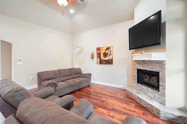 living room with ceiling fan and dark wood-type flooring