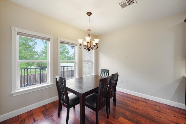 dining space with a notable chandelier and dark wood-type flooring