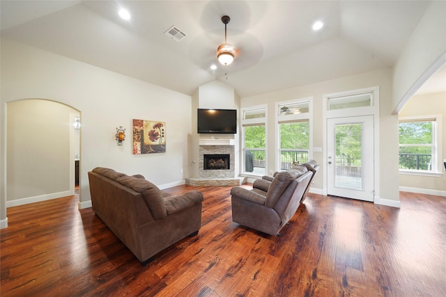 living room with dark hardwood / wood-style floors, a fireplace, and vaulted ceiling