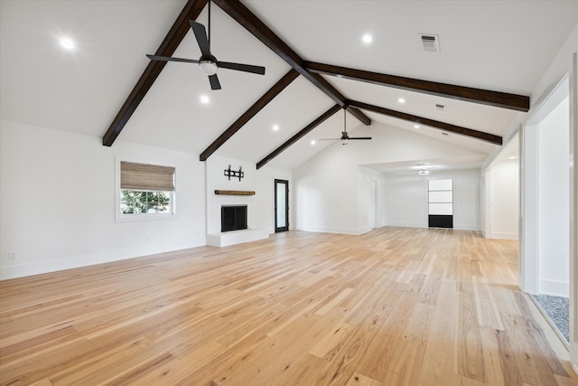 unfurnished living room featuring ceiling fan, high vaulted ceiling, beamed ceiling, and light wood-type flooring