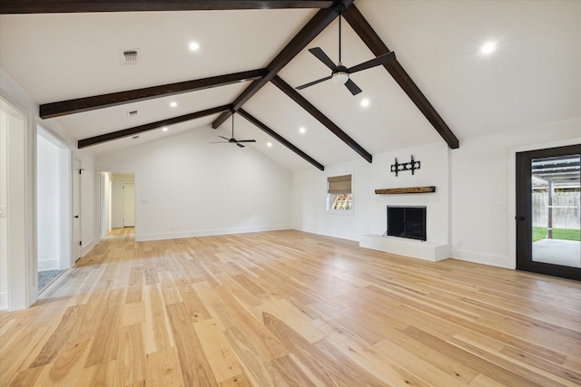 unfurnished living room featuring light hardwood / wood-style floors and lofted ceiling with beams