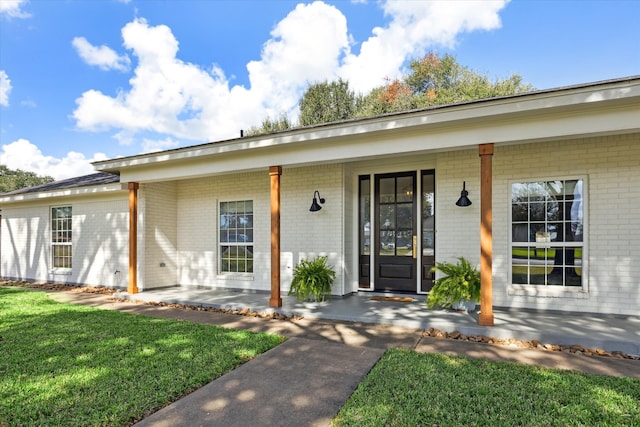 doorway to property with a yard