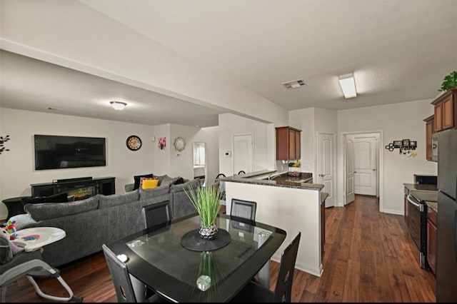 dining space featuring dark wood-type flooring