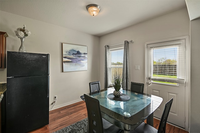 dining space featuring dark hardwood / wood-style flooring