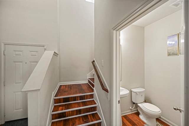 stairway featuring hardwood / wood-style floors