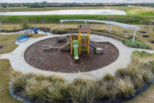 view of playground with a water view