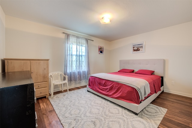 bedroom with dark wood-type flooring