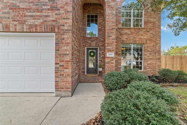 view of exterior entry with a garage