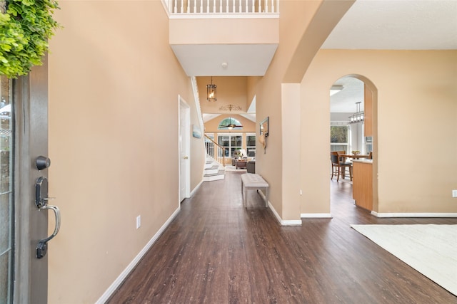 entryway featuring ceiling fan, a high ceiling, and dark hardwood / wood-style floors