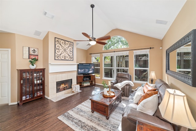 living room with a fireplace, dark hardwood / wood-style flooring, vaulted ceiling, and ceiling fan