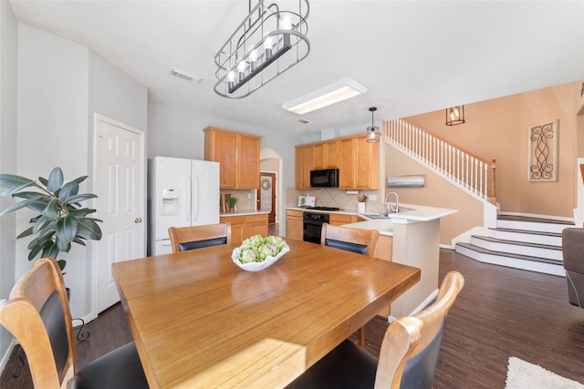 dining space featuring dark hardwood / wood-style flooring and sink