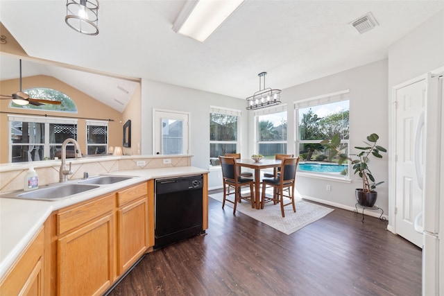 kitchen with a healthy amount of sunlight, sink, black dishwasher, and hanging light fixtures