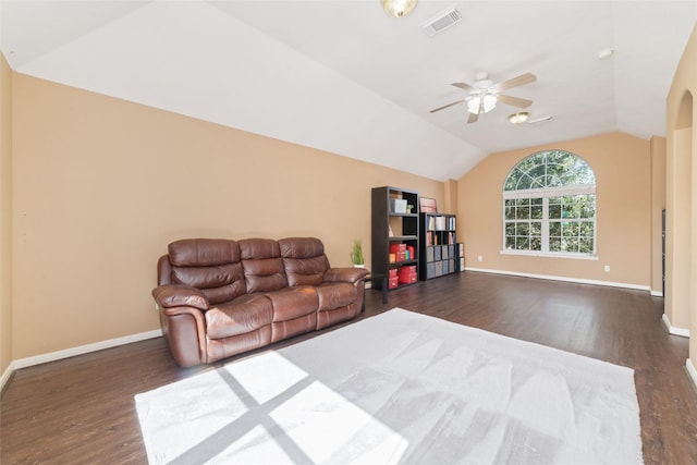 living room featuring ceiling fan, dark hardwood / wood-style flooring, and vaulted ceiling