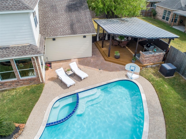 view of swimming pool with a gazebo, a patio, a wooden deck, and a lawn