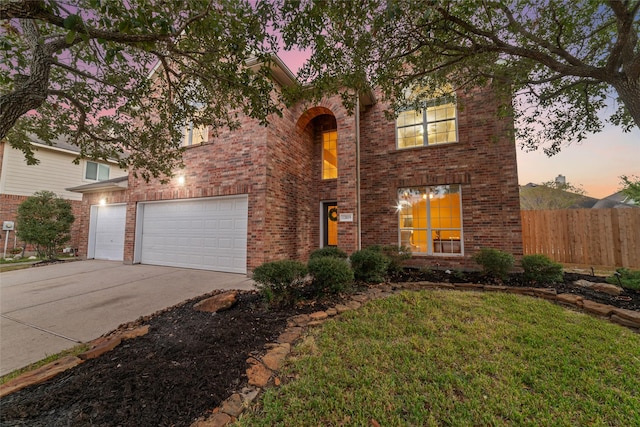 view of front of house with a yard and a garage