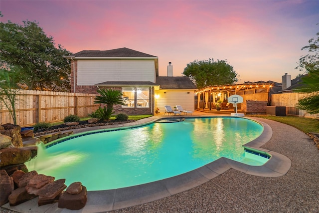 pool at dusk featuring a patio