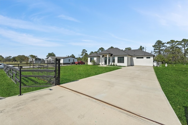 view of front of home with a garage and a front lawn