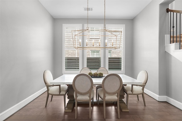 dining room with a chandelier and dark hardwood / wood-style flooring