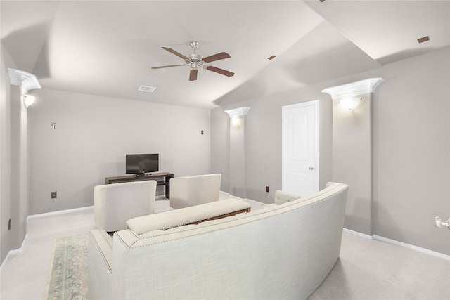 home theater featuring ceiling fan, light colored carpet, ornate columns, and vaulted ceiling