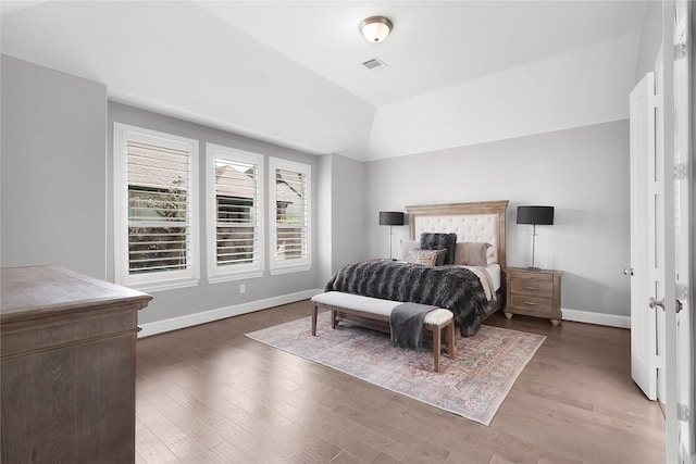 bedroom featuring vaulted ceiling and hardwood / wood-style floors