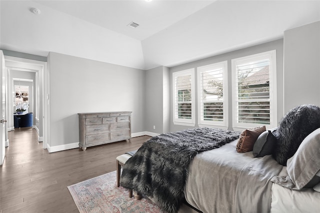 bedroom featuring vaulted ceiling and dark hardwood / wood-style floors