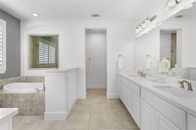 bathroom with vanity, tile patterned flooring, and plus walk in shower