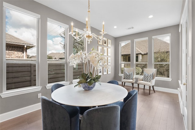 dining space featuring a chandelier and wood-type flooring