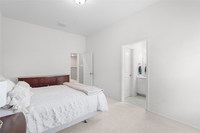 carpeted bedroom with ensuite bathroom