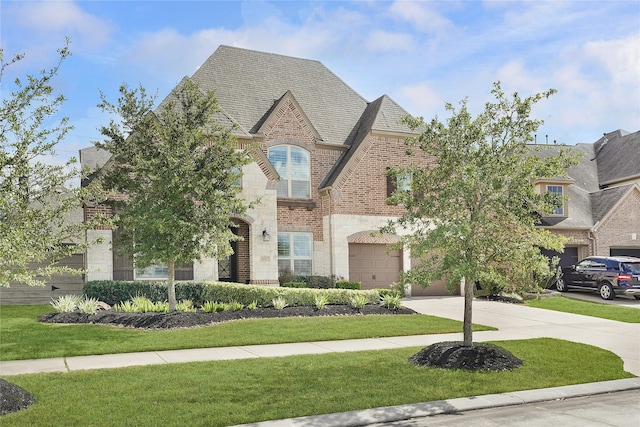 view of front of house with a front yard and a garage