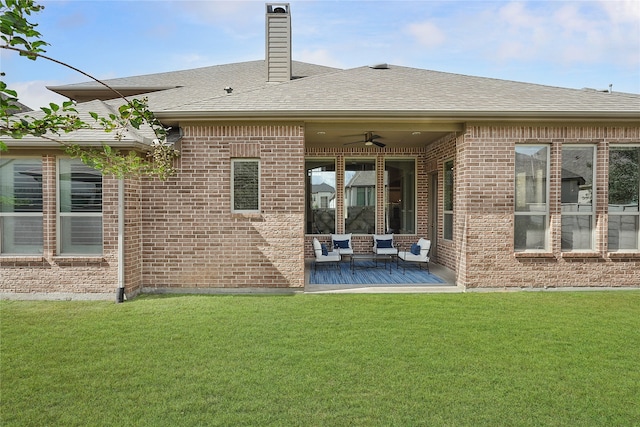 back of property with a patio, a lawn, and ceiling fan