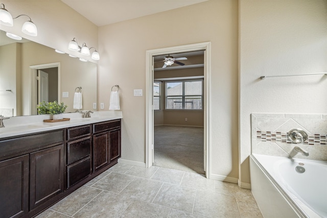 bathroom featuring ceiling fan, a bathtub, and vanity