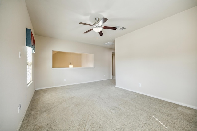 empty room featuring carpet flooring and ceiling fan