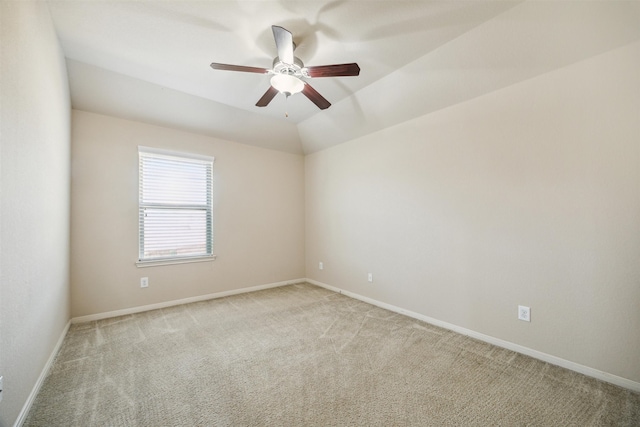 carpeted spare room with ceiling fan and lofted ceiling