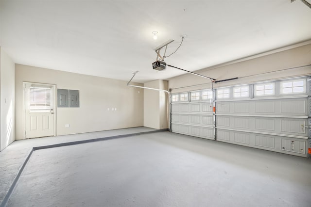 garage with electric panel and a garage door opener